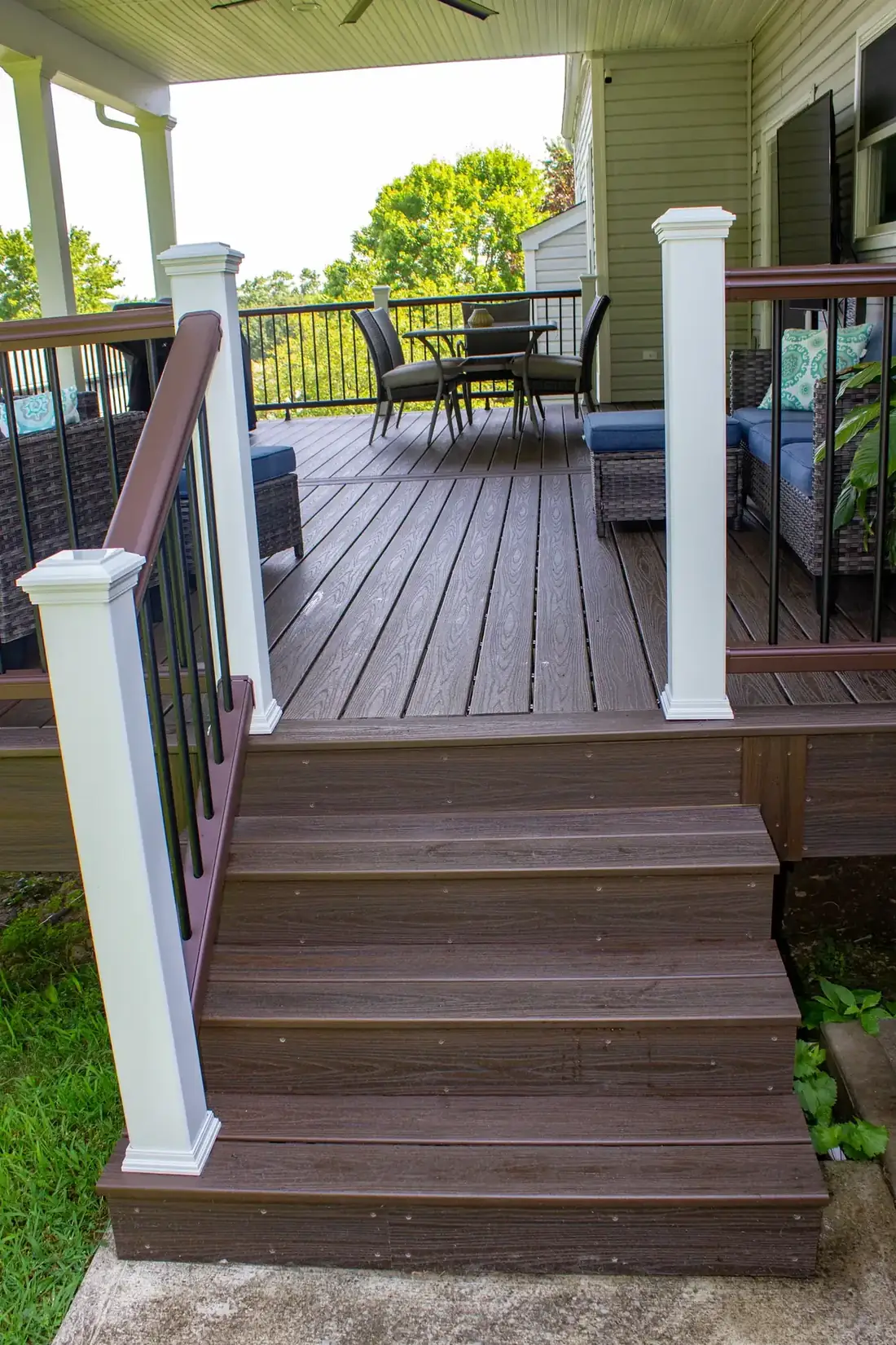Stair detail — composite treads, aluminum balusters — Oasis Custom Decks