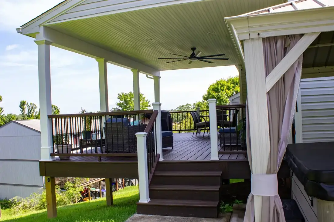 Under the roof: fan, lighting, black aluminum rail — Oasis Custom Decks