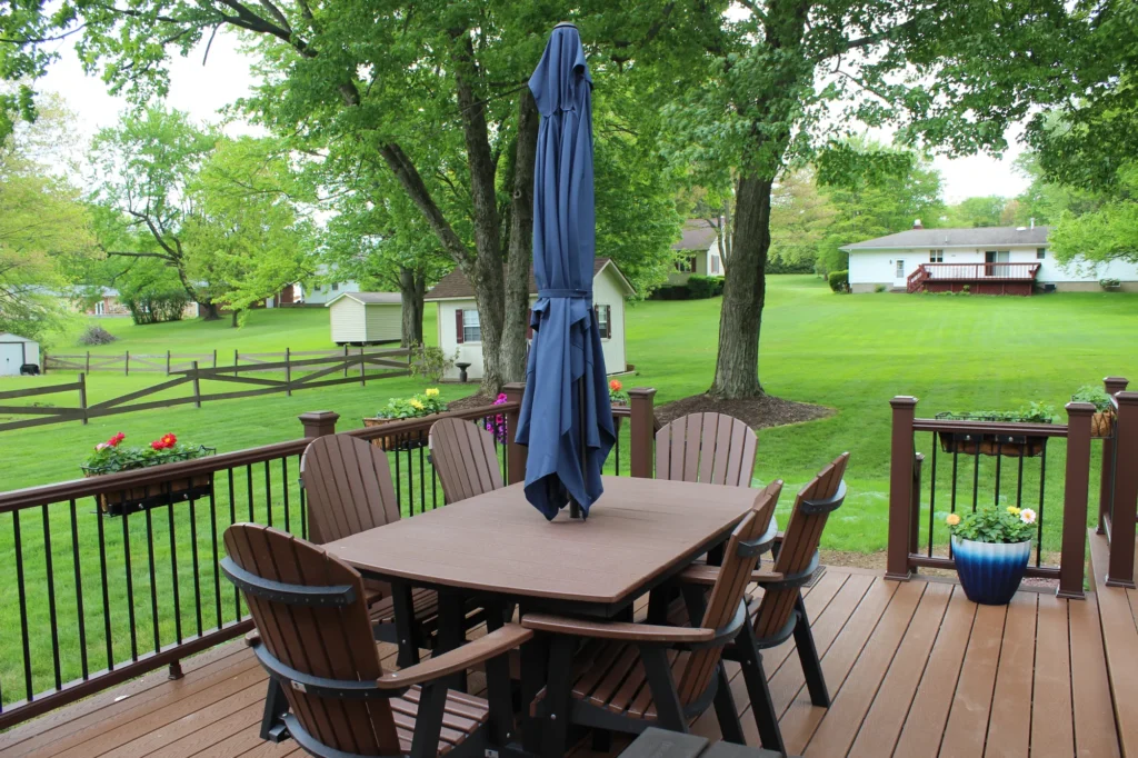 Photo of a deck featuring a table, with a parasol on the table