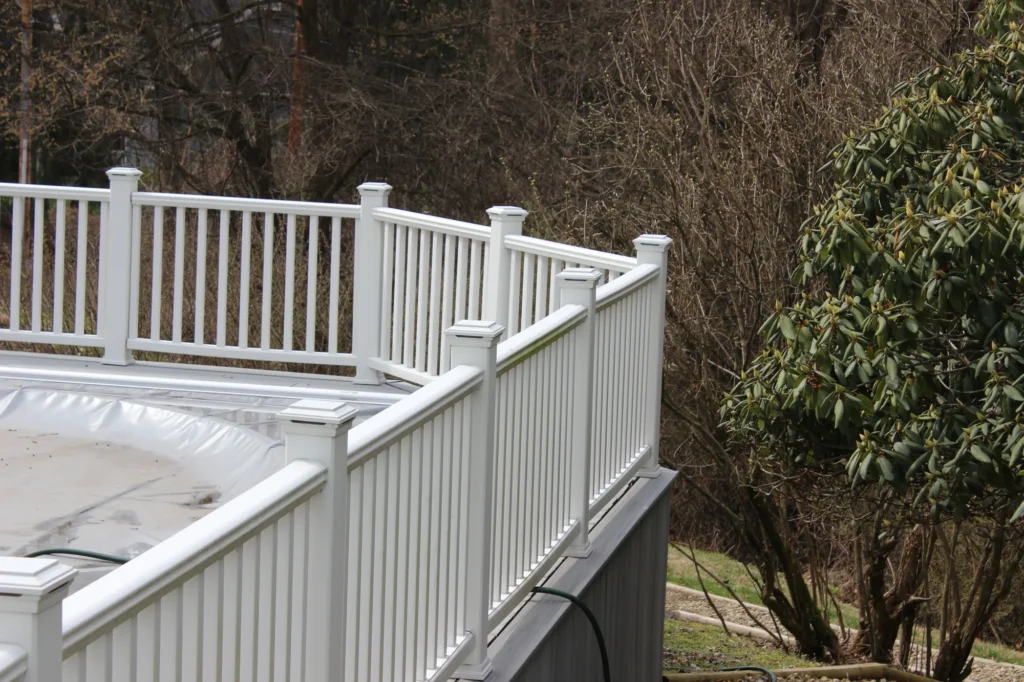 A close-up of what a wooden deck railing looks like; this one is painted white