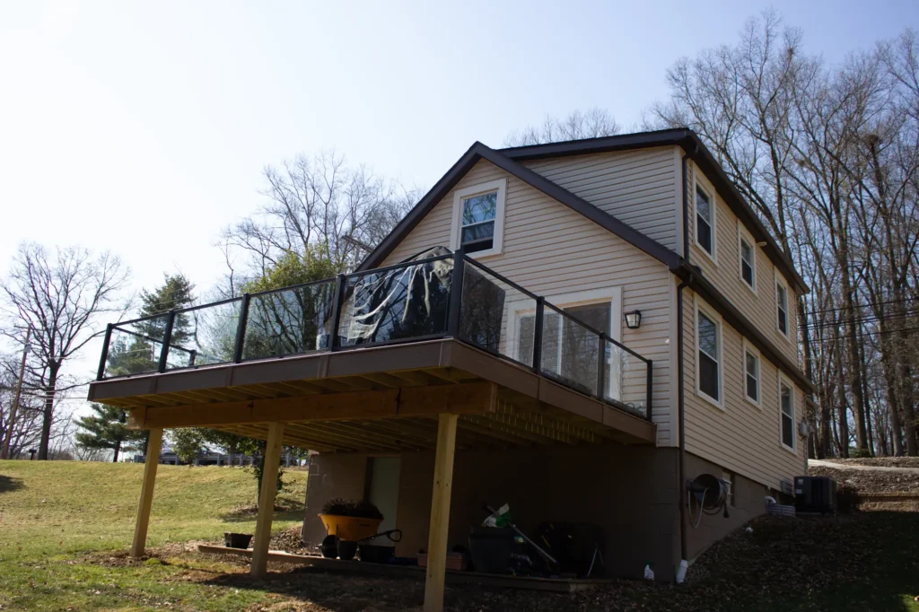 A distant view of a raised deck featuring a glass railing