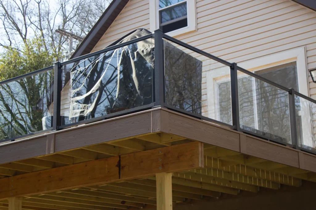 Another view of a raised deck featuring a glass railing