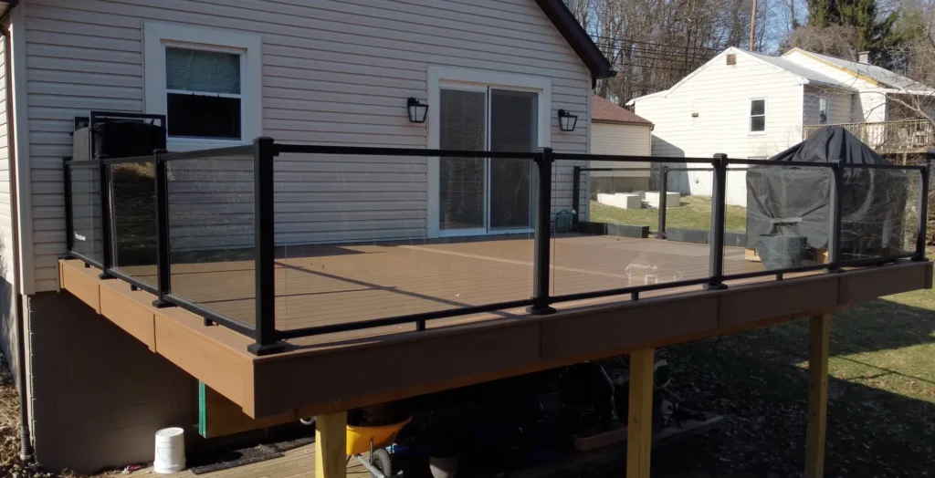 Photo of a raised deck featuring a glass railing