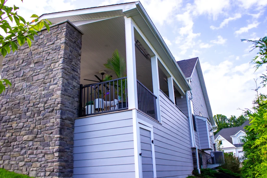 Photo of a deck taken from the outside, showing a different perspective that reveals it is an elevated deck