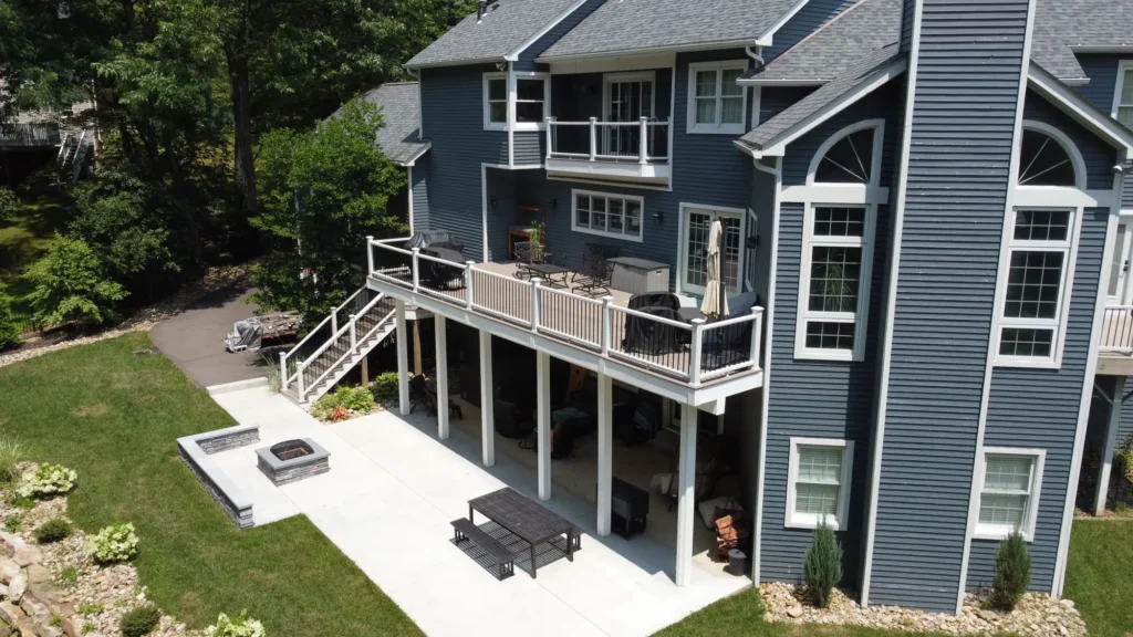 Photo of a raised deck located on the second floor of a house, featuring stairs leading up to the deck